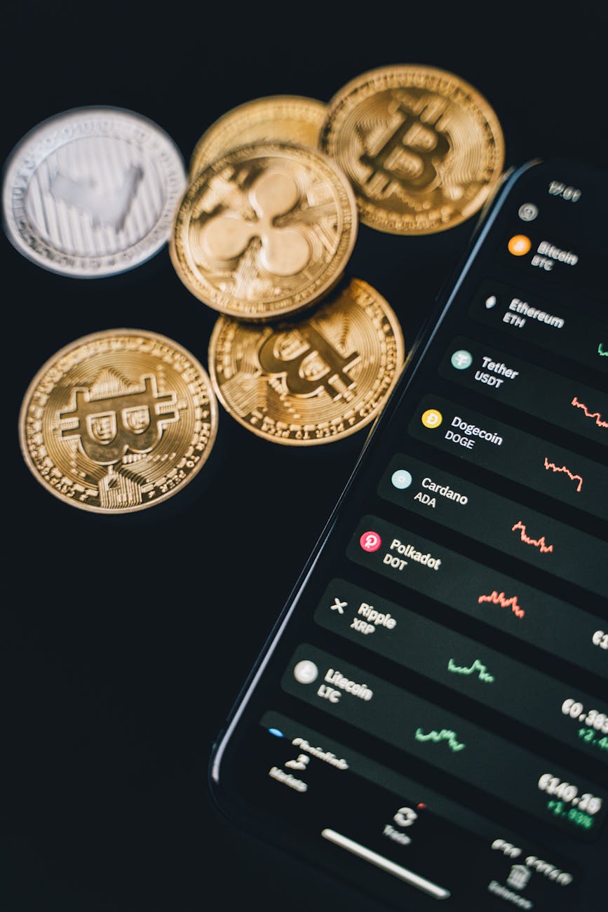 mobile phone beside bitcoins